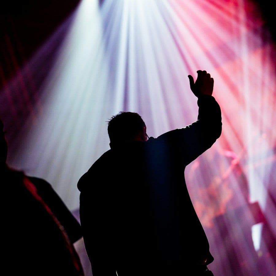 Young believers raising hands in worship